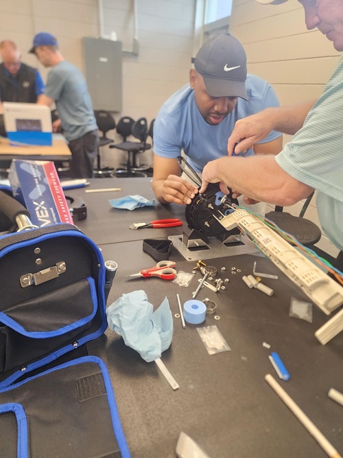 Fybe techs putting electronics together