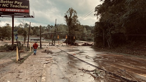 Hurricane Helene in Asheville A washed out street with downed power lines in Asheville NC