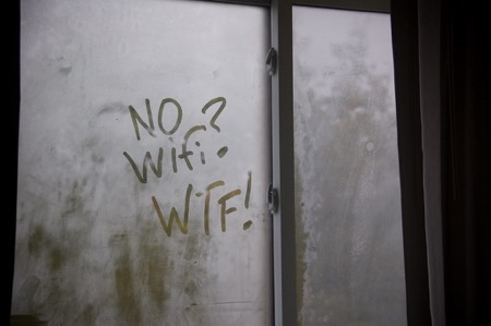 No Wifi WTF  A fogged window has a message written by someone's finger: "No WiFi? WTF!"