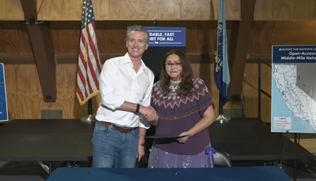 Gov. Gavin Newsom shaking hands with Bishop Paiute Tribe Chairwoman Emma Williams