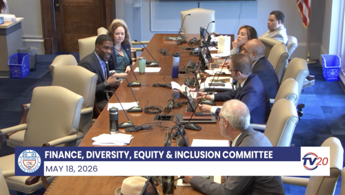 DigitalC CEO Josh Edmonds sits across the table from city councilors in meeting