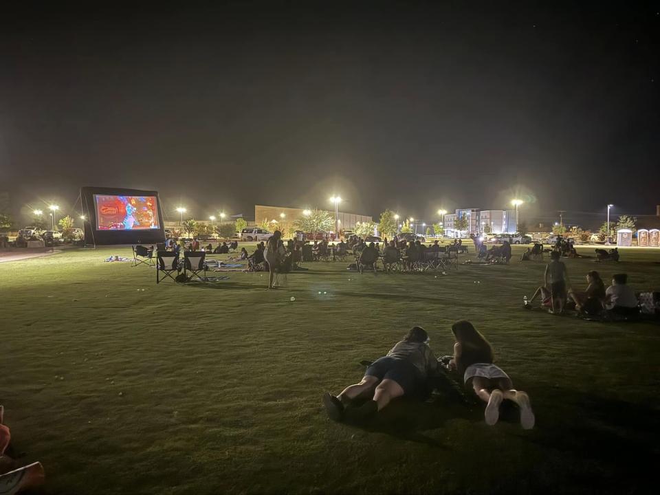 Monahans TX night event  Residents lay in athletic field under lights at night event