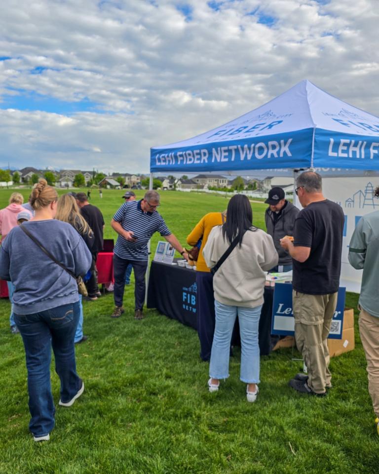 Lehi Fiber open house gathering where several community members gather outside a sign-up for service tent
