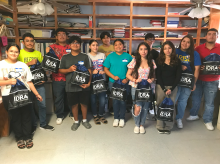 Digital Opportunity Lab Students holding back pack group pic