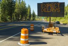 An electronic sign on highway reads: "Expect Delays"